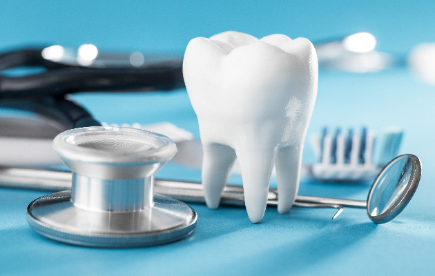 White healthy tooth, different tools for dental care.